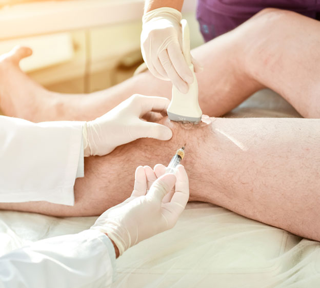 Orthopedic surgeon giving a patient a cortisone injection in the knee