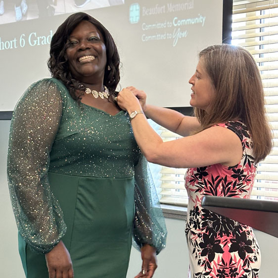 A lapel pin is placed on Letitia Washington