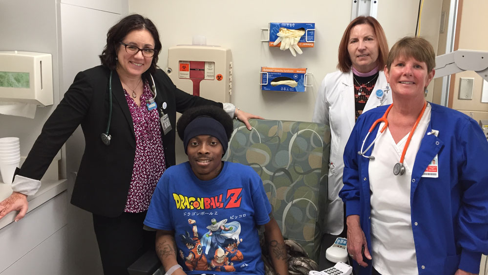 Dr. Julie Kanter, clinic patient Nicholas Black, clinic staff nurse Annemarie Gault, NP and Janice Bristow, director of nursing supervision & float pool.