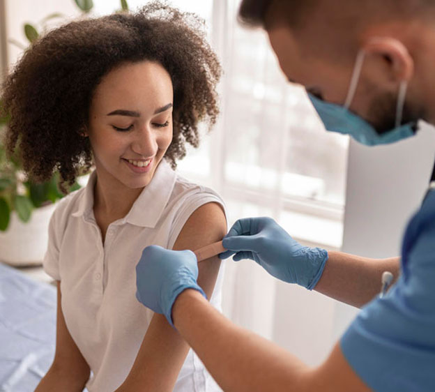 Woman receiving a flu shot from her provider