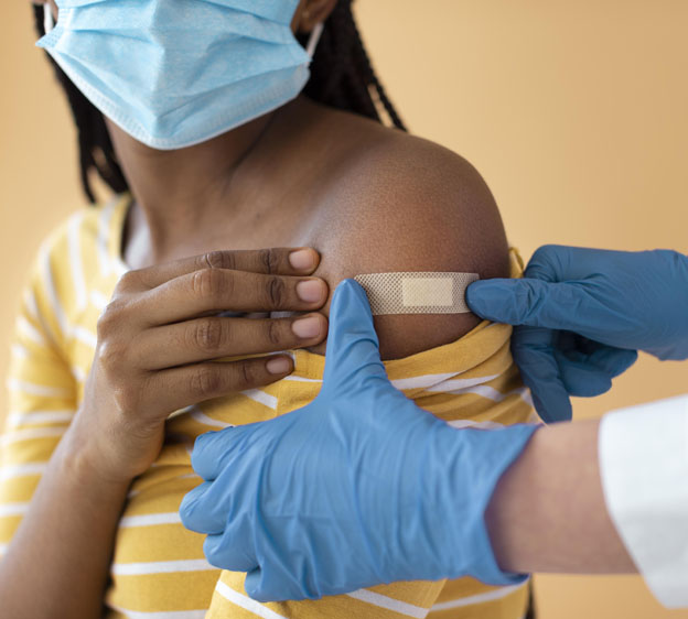 woman showing her band-aid from her covid vaccination