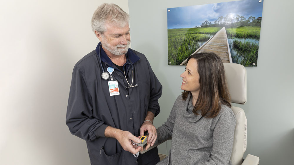 nurse measuring oxygen in blood with pulse oximeter