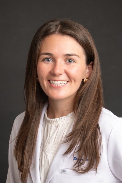 Professional portrait of Brooke Cox, PA-C in a white lab coat/
