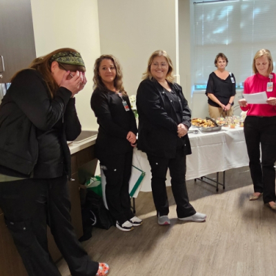 Annie Loughlin, RN, BSN reacts to finding out she is a DAISY award recipient and that her family is in the room