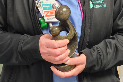 Nancy Morrison, RN, BSN, holds her DAISY award